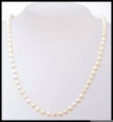 A 20th century pearl necklace of Chinese origin being cultured set to a white metal clasp with