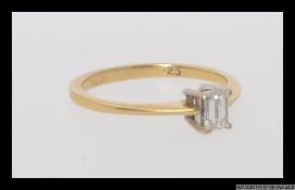An 18ct 750 gold ring set with a single emerald cut diamond of .25pts. Hallmarked for Birmingham.