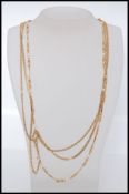 A 20th century yellow metal and faux seed pearl set 3 string necklance.
