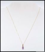 A 9ct gold and amethyst pendant and necklace.