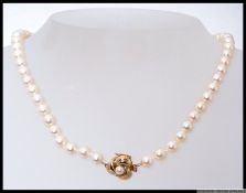 A ladies cultured pearl and  yellow metal necklace.