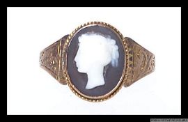 A 19th century yellow metal cameo set ring with chased foliate decoration to shoulders.  Size Q.