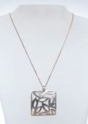 Contemporary pierced silver pendant on a fine silver chain stamped 925, silver maker SB.