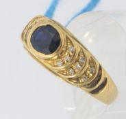 A ladies yellow gold sapphire and diamond ring. The central sapphire being round cut.