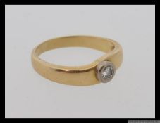 An 18ct gold and diamond ring with a single round cut diamond of approximately .
