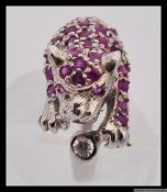 A 925 silver designer ring styled in the shape of a panther encrusted with pave set red gem stones.