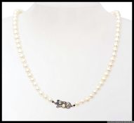 A ladies cultured pearl and white metal necklace.