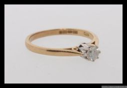 A 9ct gold and diamond solitaire ring set with a single round cut diamond of approximately 25pts.