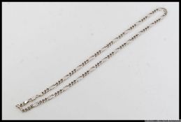 A silver figaro chain silver necklace with marks for silver Sheffield maker AJ Ltd. Length 20