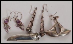 A collection of 4 sets of earrings.