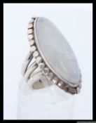 A silver dress ring with large oval gem set stone stamped 925. Size P.