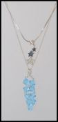 An Italian silver necklace with blue bead pendant together with a pave set drop star pendant