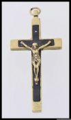 A large vintage white metal crucifix cross pendant emelished with a figure of Christ with an eboney