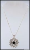 A 925 silver pendant necklace in a large snowflake stylised setting with black onyx central stone