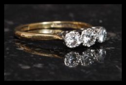 An early 20th century 3 stone 18ct gold and platinum diamond ring marked for Bravingtons.