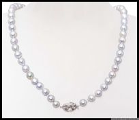 A ladies silvered cultured pearl and white metal necklace.