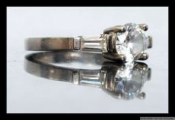 A ladies silver 925 dress / cocktail ring having central round cut CZ stone being claw mounted with