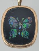 A 9ct gold vintage opal mosaic butterfly pendant. Marks worn. Measures 2cms x 1.3cms.Weight 1.2g.