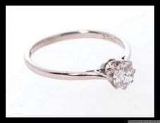 An 18ct white gold and diamond single stone claw set solitaire ring with wonderful inset stone