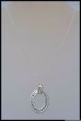 A 925 pendant necklace with large oval CZ Halo pendant with Buguette and round cut CZ.