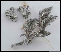 A ladies marcasite vintage brooch and earring set.
