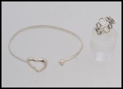 A designer heart clasp bangle together with a graduated bubble ring. Stamped 925. Ring size K.