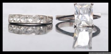 Two silver dress rings set with clear gem stones stamped 925. Sizes P & O.