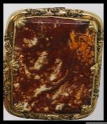 A Victorian pinchbeck brooch set with moss agate in shell and foliate stylised mount.