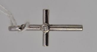 A 9ct white gold crucifix set with a single diamond of approximately 4 points.