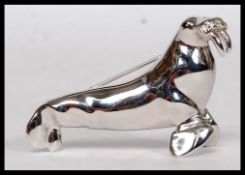 A vintage D'Orlan white metal brooch in the form of a walrus.