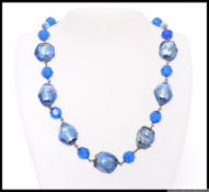 A vintage 1930s peacock blue Bohemian art glass bead necklace with faceted and foil lined glass and
