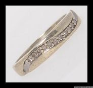 A 9ct gold and diamond ring with .10ct diamonds in a channel setting. Hallmarked for Birmingham.