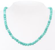 A 9ct gold and green spotted tree agate stone Chinese necklace. Set with a 9ct gold clasp.