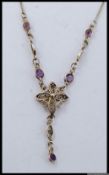 Art Nouveau style silver necklace with filigree foliate decoration with amethyst style gem stones
