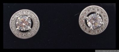 A pair of 925 silver designer halo earrings with central CZ stone surrounded by a round cut CZ halo