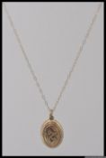 A 9ct gold necklace and locket pendant.