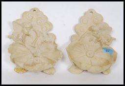 A pair of resin set wall pockets each ad