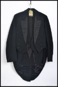 A gentlemans mid century evening wear tails suit comprising trousers waistcoat and jacket.