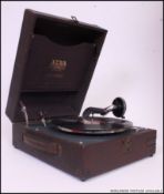 An excellent early 20th century Alba portable gramaphone set in a faux snakeskin red vinyl case