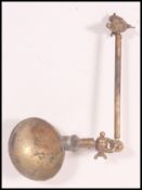 An early 20th century brass desk mounted telescopic anglepoise bankers lamp of industrial form
