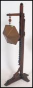An unusual large oak and brass floor standing gong with adjustable height settings on ratchet style