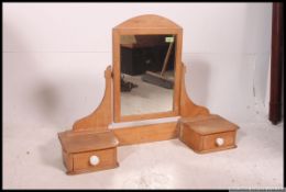 A Victorian pine swivel dressing table swing mirror flanked by twin trinket drawers.