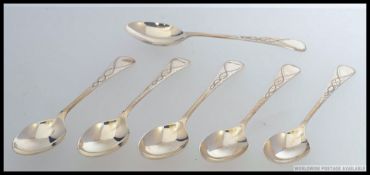 A set of 6 silver hallmarked spoons having chased scrolled  handles.