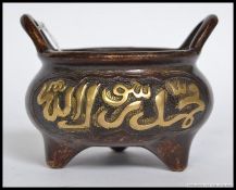 A Chinese bronze censur - ding embellished in relief with brass character marks being raised on 3