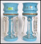 A Victorian pair of blue glass table lustres.