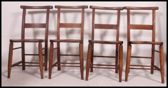 A set of 4 Victorian beech and elm chapel chairs.