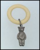 A hallmarked silver babies rattle, affixed to the original plastic ring.