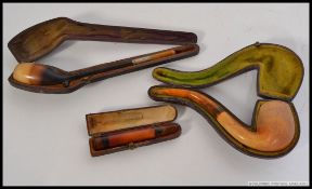 A collection of pipes to include a Meerschaum and amber mouth piece cased pipe.