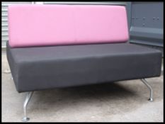 A retro style two tone twin / double sided low lounger settee raised on chrome tapered legs by