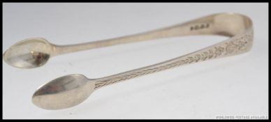 A pair of silver hallmarked sugar tongs with a Birmingham assay mark dated to 1845, 31.